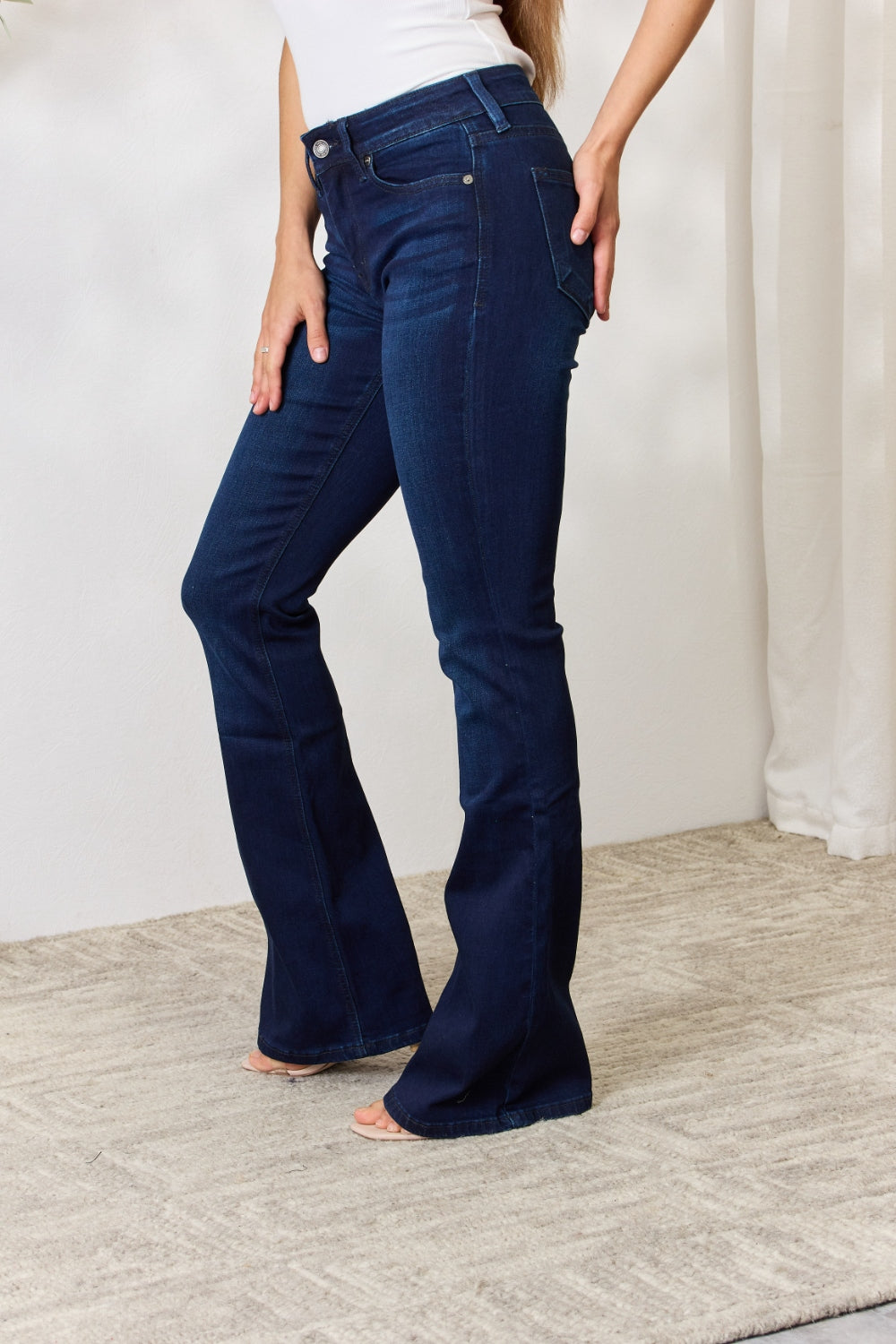 Discover the chic Kancan Mid Rise Flare Jeans. Perfect stretch, timeless style, and a flattering fit for every size. Elevate your denim game!