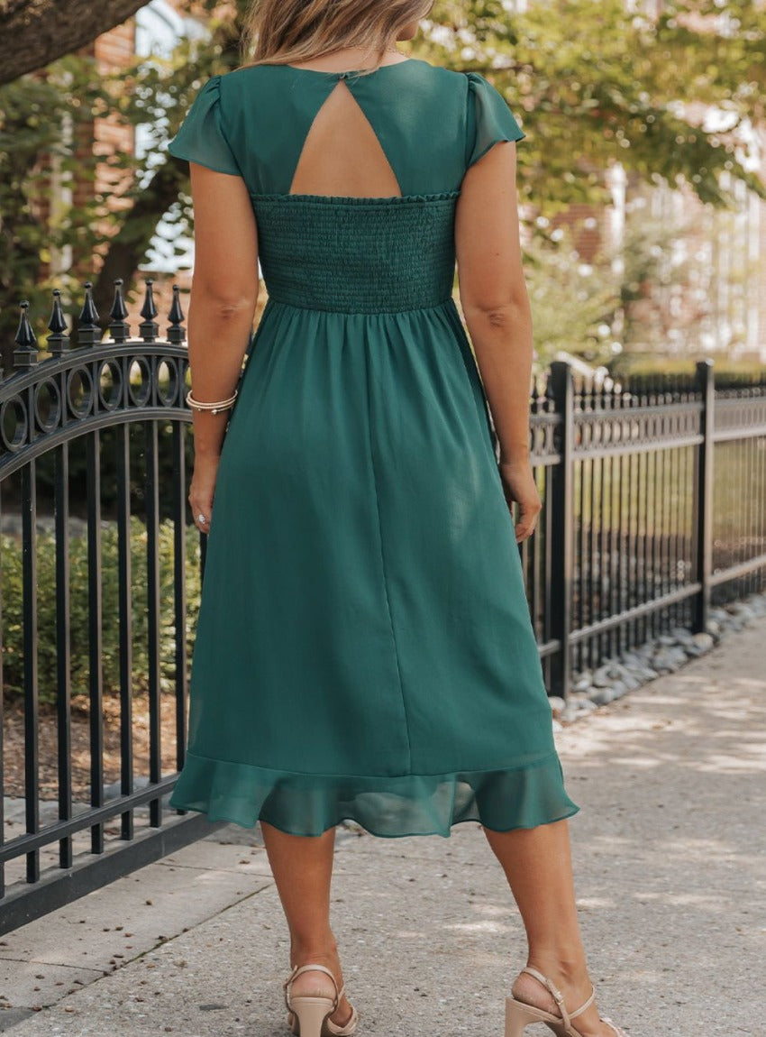 Stunning cap sleeve dress with chic cutouts and ruffled hem for a graceful, versatile look. Perfect for any occasion
