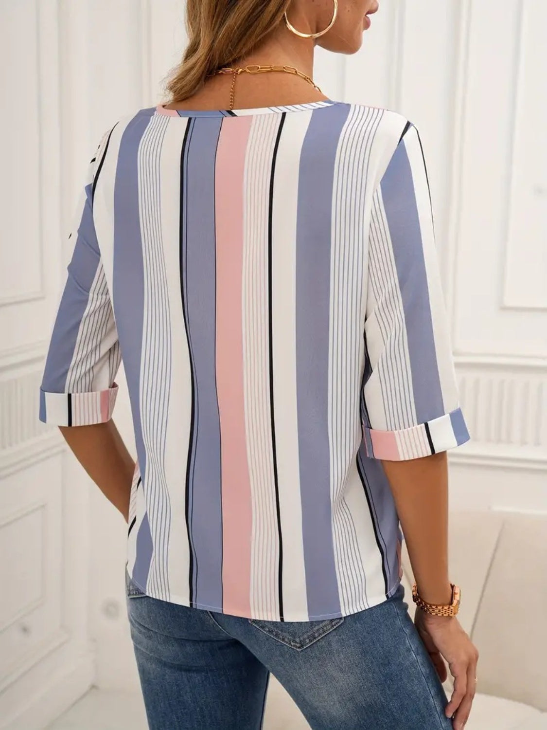 Stylish pastel striped blouse with round neckline and 3/4 sleeves