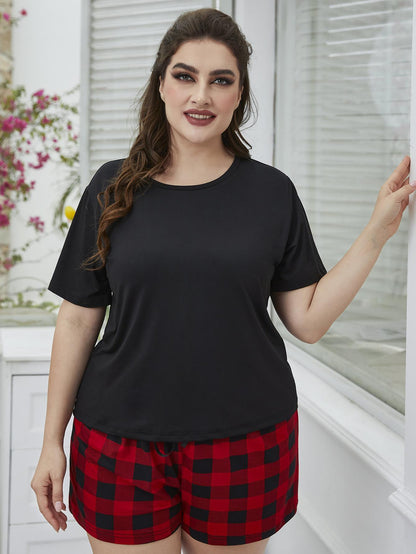 Plus size lounge set with black top and red plaid shorts