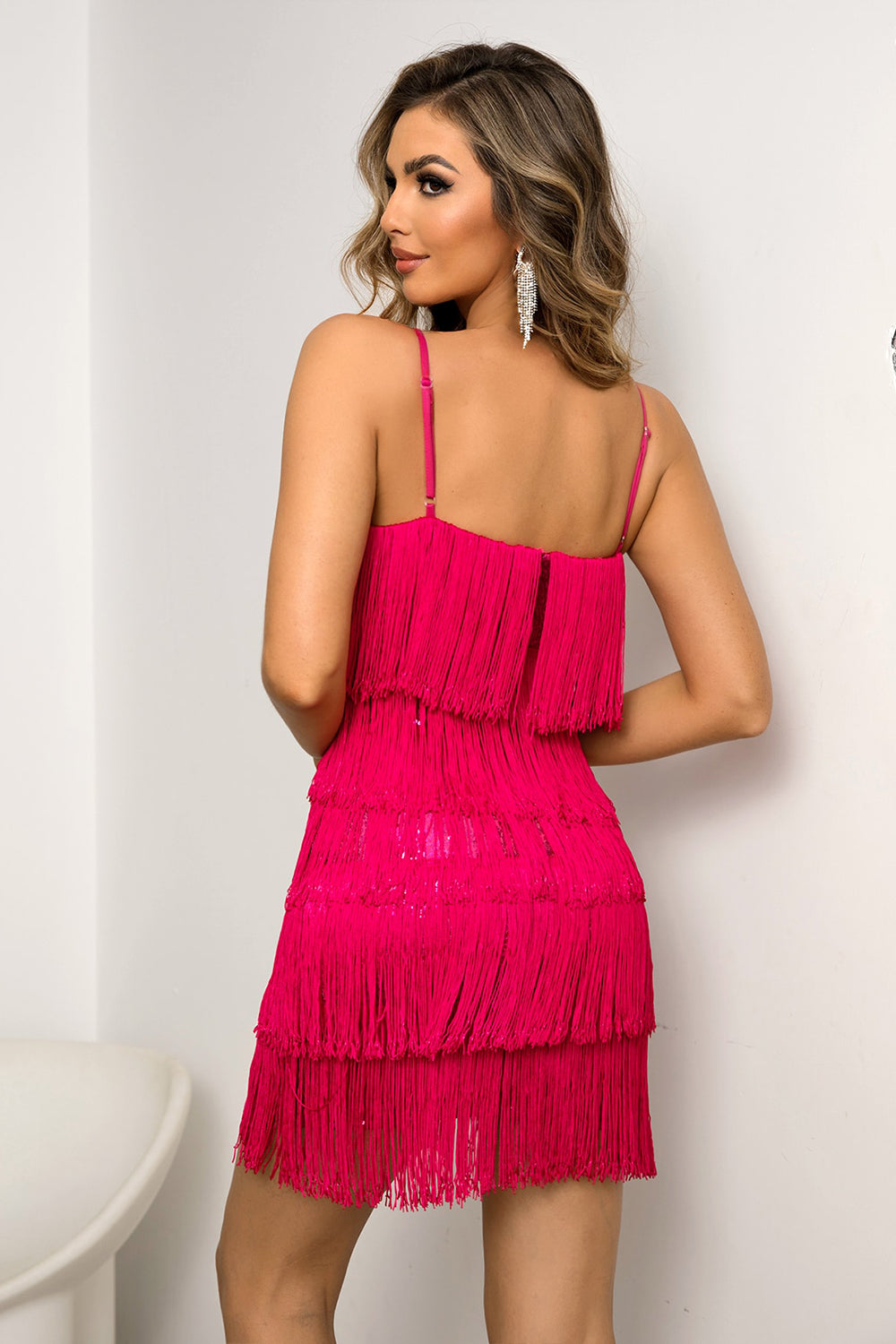 Turn heads with our Spaghetti Strap Fringe Mini Dress, perfect for any chic occasion. Feel fabulous and dance the night away in vibrant style.
