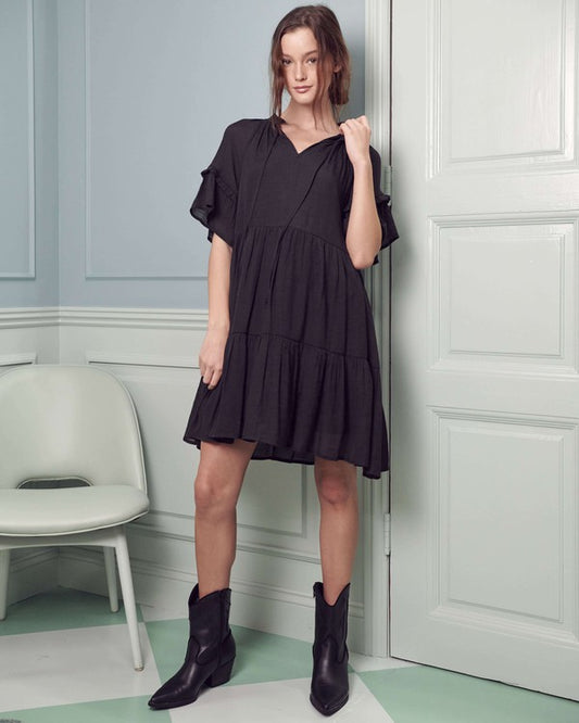 Casual black boho dress with a tiered design and ruffled sleeves.