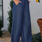 Blue wide-leg lyocell pants with roomy front pockets and comfortable fit.