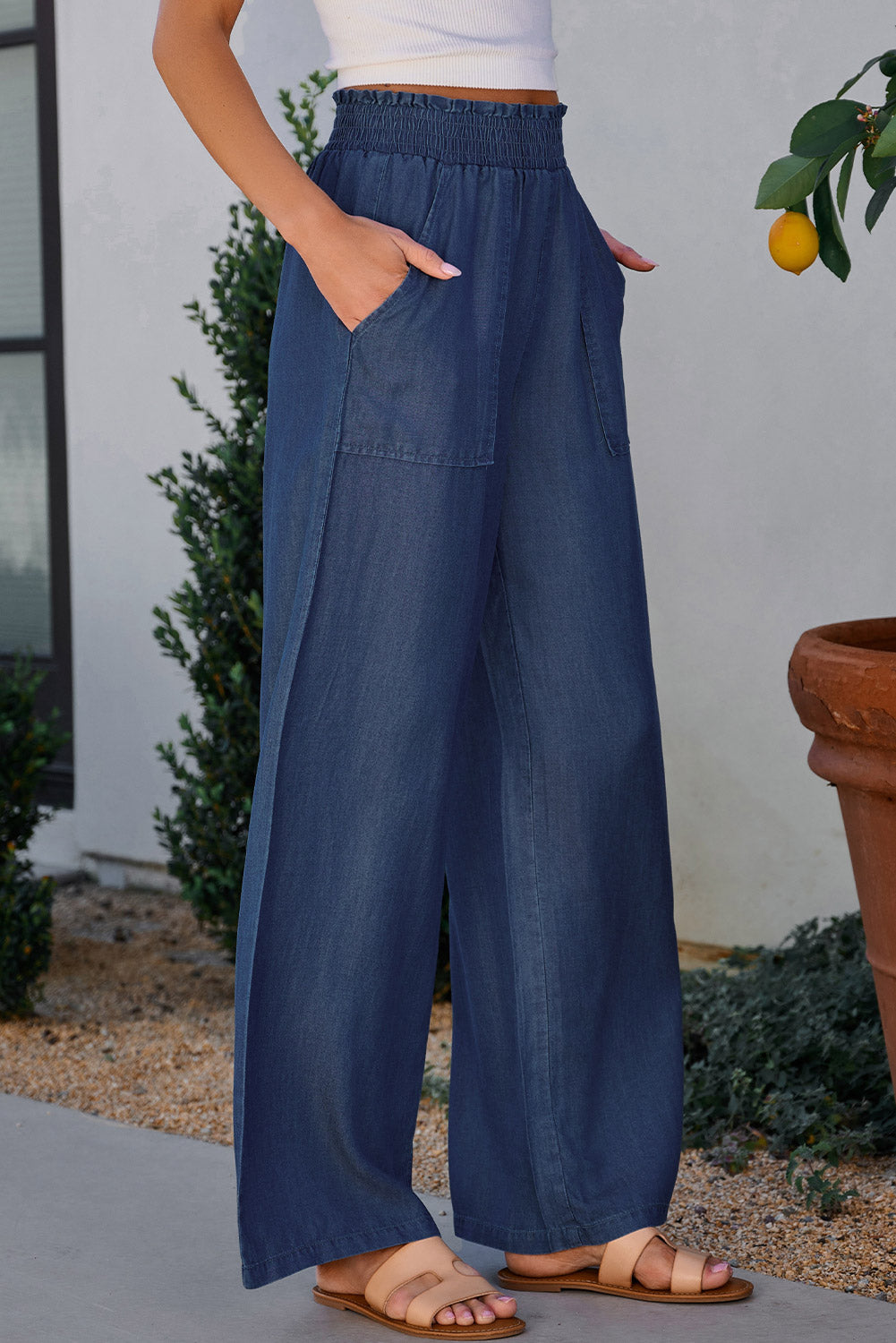 Blue wide-leg lyocell pants with roomy front pockets and comfortable fit.