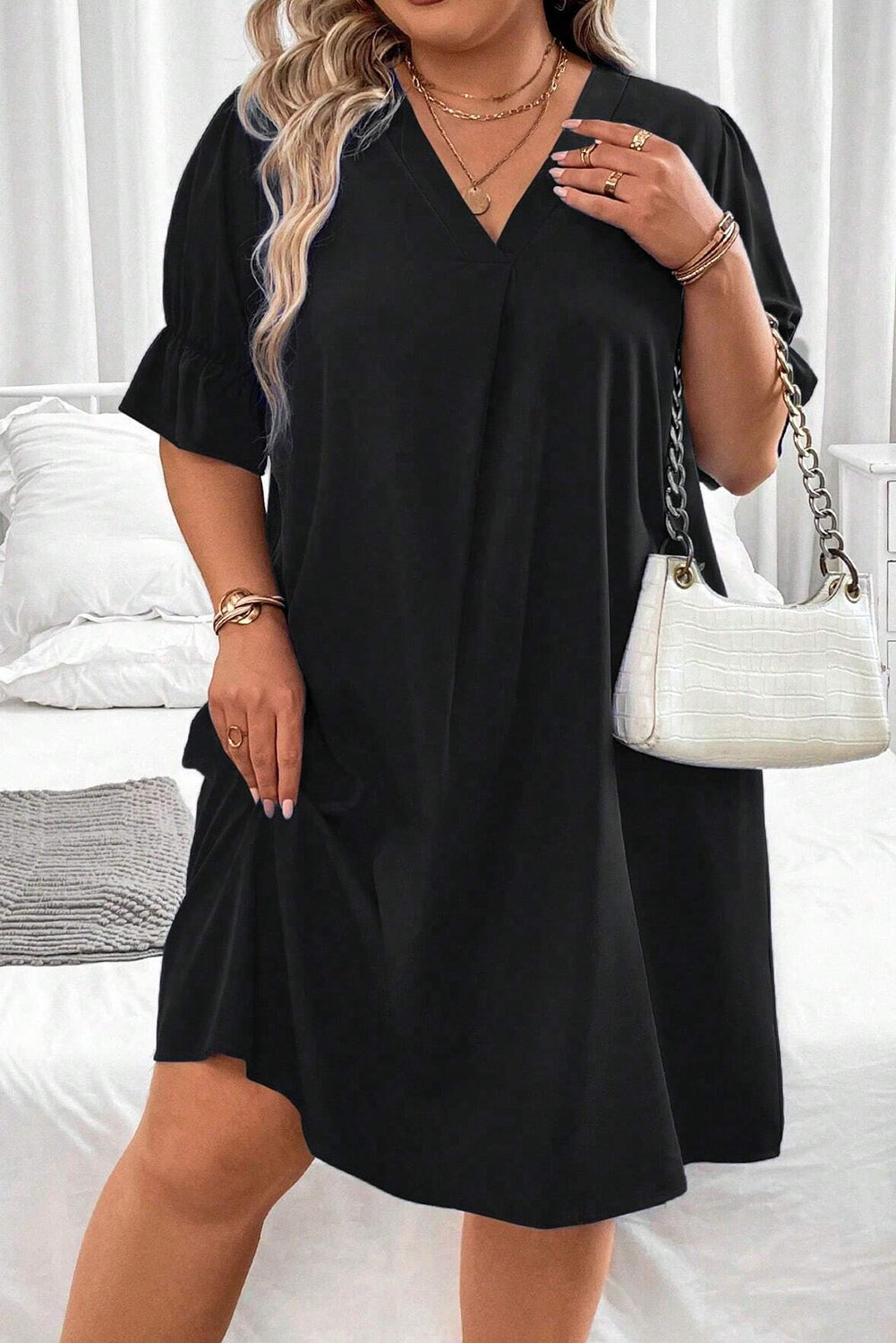 Elevate your style with our Plus Size Mini Dress featuring a chic V-neck and ruffled puff sleeves for a flattering, fashionable look.