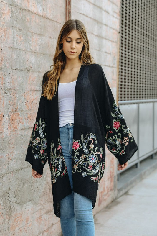 women's kimono with colorful floral embroidery on sleeves and hem
