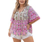 Women's pink floral top with tassel-trimmed sleeves and intricate neckline
