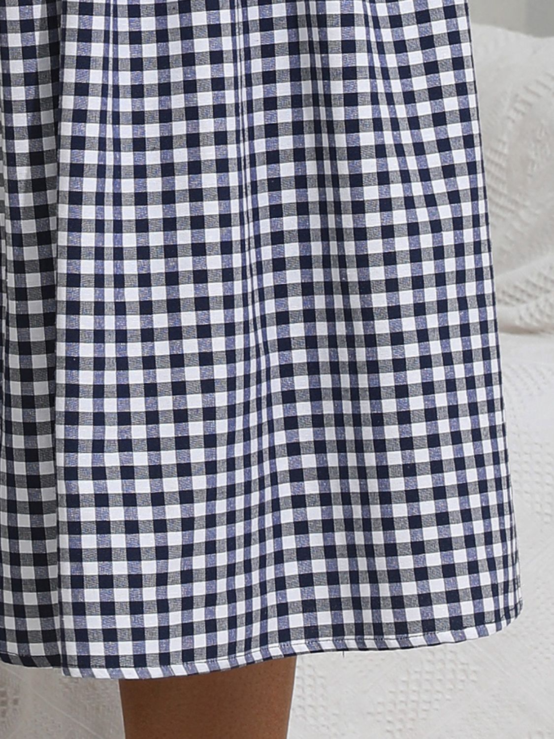 Casual blue gingham dress with a smocked top and midi length