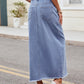 Casual denim skirt with a raw hem and front slit.