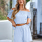 Light blue off-shoulder top and shorts set.