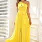 Full-length yellow gown with a single shoulder strap and a delicate waist tie