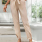 Beige pants featuring a unique boho pattern and adjustable waistband.