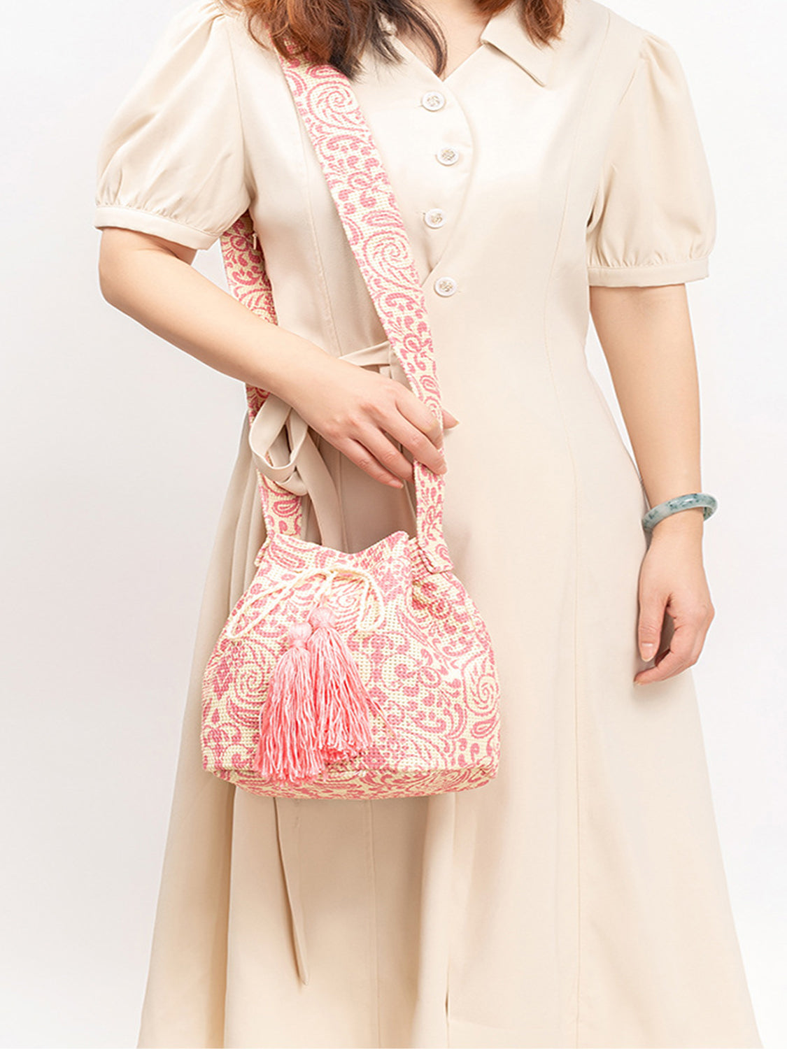 Pink and cream bohemian bucket bag with drawstring and tassels.