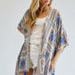 Flowy kimono with colorful geometric patterns, available in yellow and blue