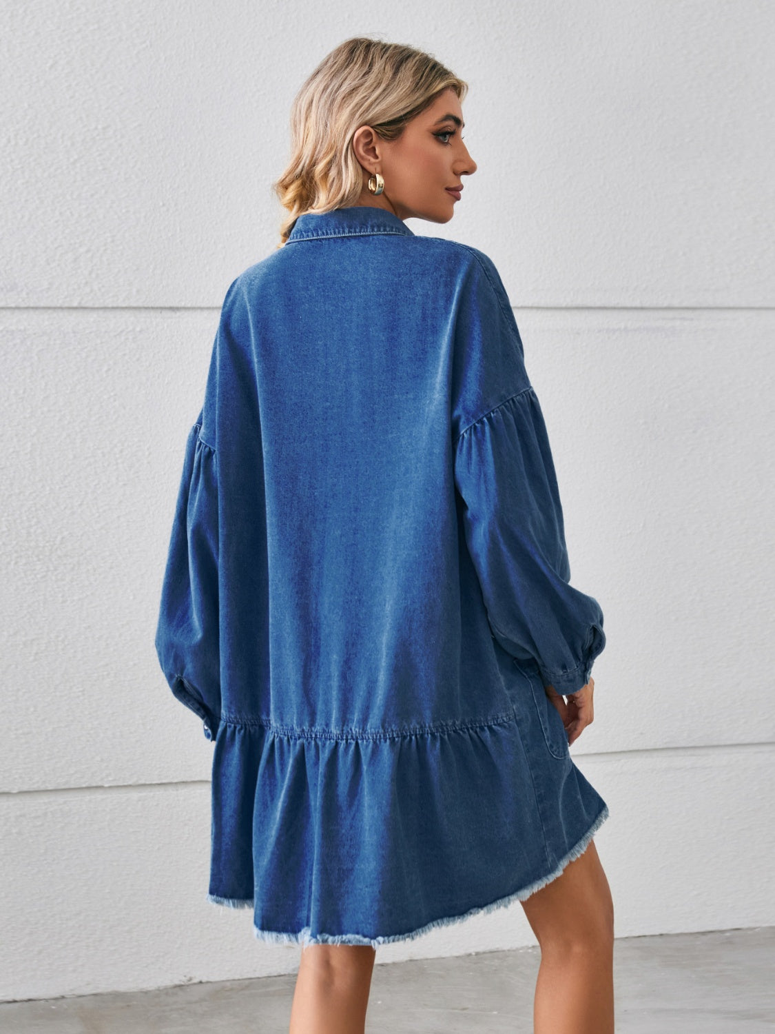Chic denim dress with a trendy raw hem, comfy fit, button-up front, and handy pockets—perfect for a casual yet stylish look.