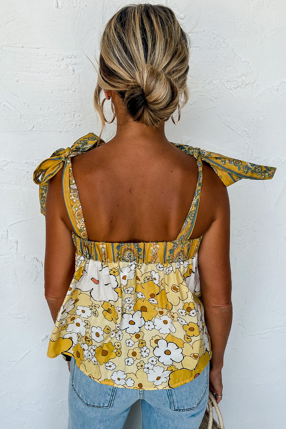 Embrace boho charm with our Yellow Floral Knot Top, perfect for a sunny day out. Lightweight, adjustable, and effortlessly stylish