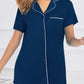 Chic short sleeve lounge dress with contrast piping and pockets, in sky blue, black, and navy. Perfect blend of comfort and style for any occasion