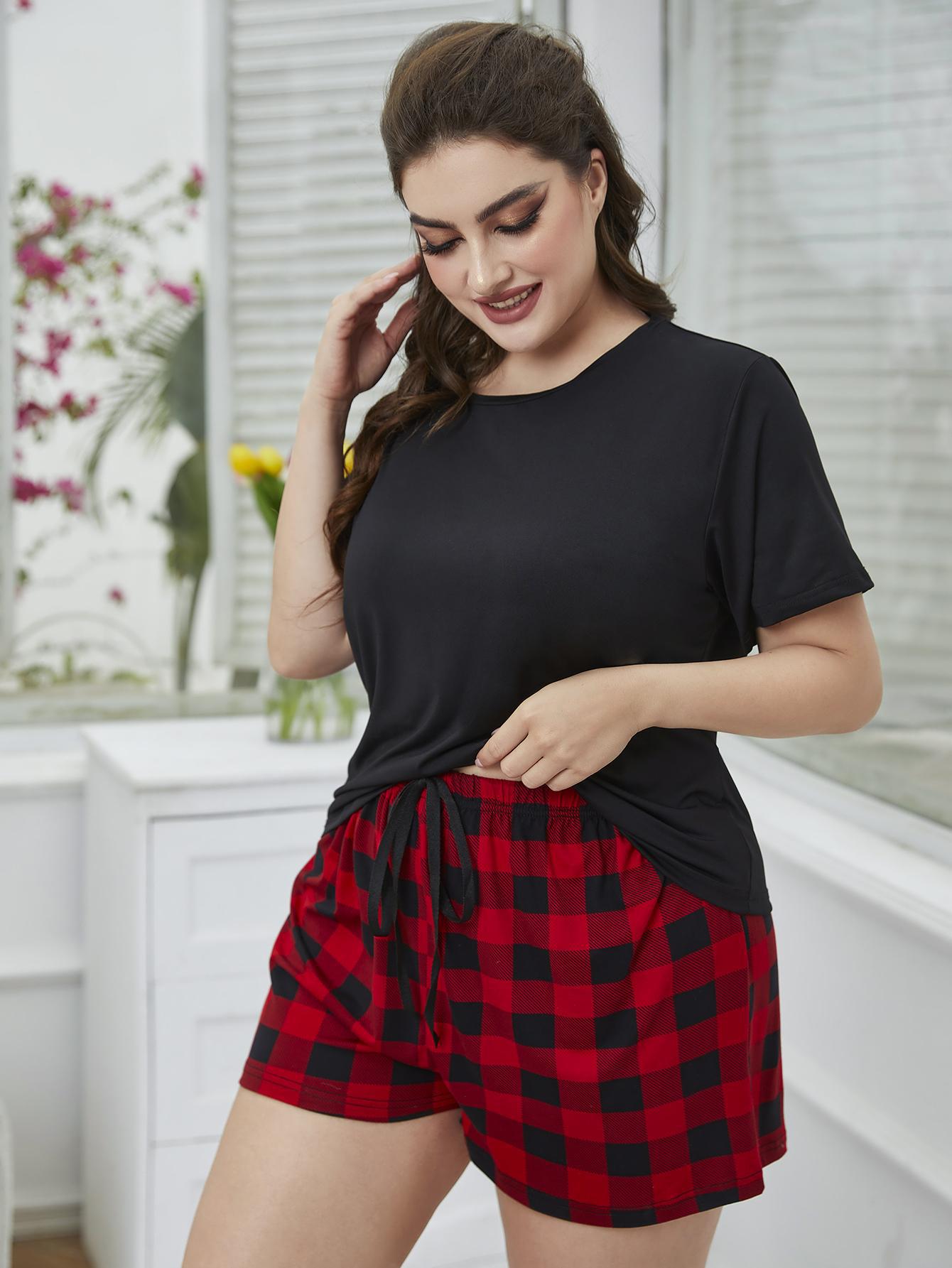 Cozy plus size lounge wear featuring a black tee and red plaid shorts