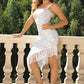 Elegant fringed dress with asymmetrical hem for a stunning, figure-flattering look. Perfect for any chic occasion.