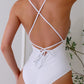 Elevate beach days with our chic one-piece swimwear, featuring a unique crisscross design and customizable lace-up front for a perfect fit. This white bathing suit will quickly become your go to for the summer!