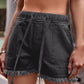 Versatile & stylish Drawstring Denim Shorts with a chic raw hem. Perfect for summer days & available in a variety of colors