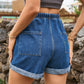 Chic high-waist denim shorts with a comfortable drawstring, roomy pockets, and a versatile roll-up hem for the perfect summer look