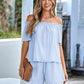 Stylish off-shoulder top and shorts set in light blue.