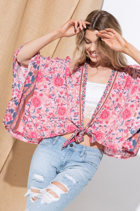 Pink floral kimono with flowy fit and lightweight fabric.