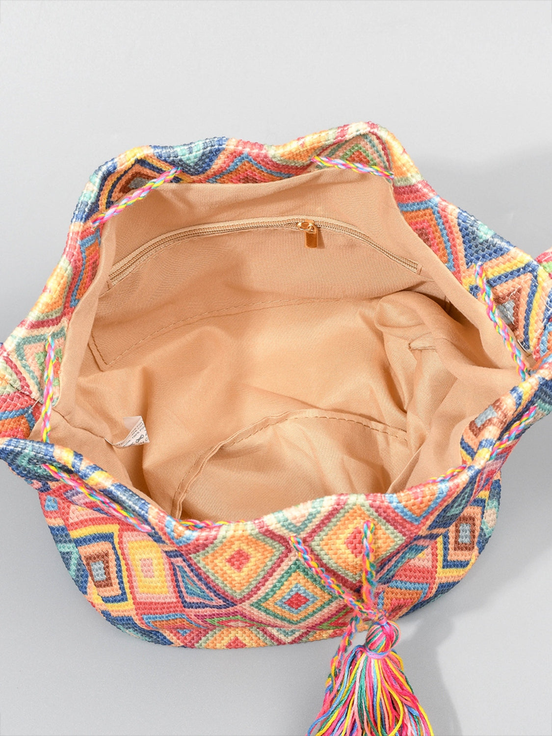 Colorful boho bucket bag with intricate woven patterns.