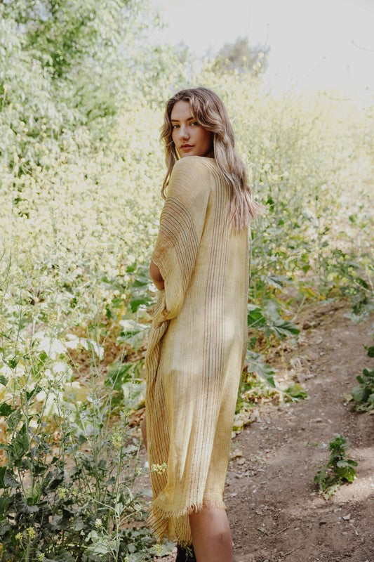 Sheer yellow kimono with breathable material.