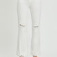 Button fly white jeans with ripped knees and high-waisted fit.