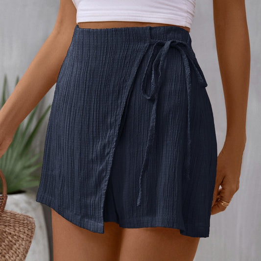 Chic navy high-waist skort with a flattering tie feature, blending elegance with comfort for everyday wear.