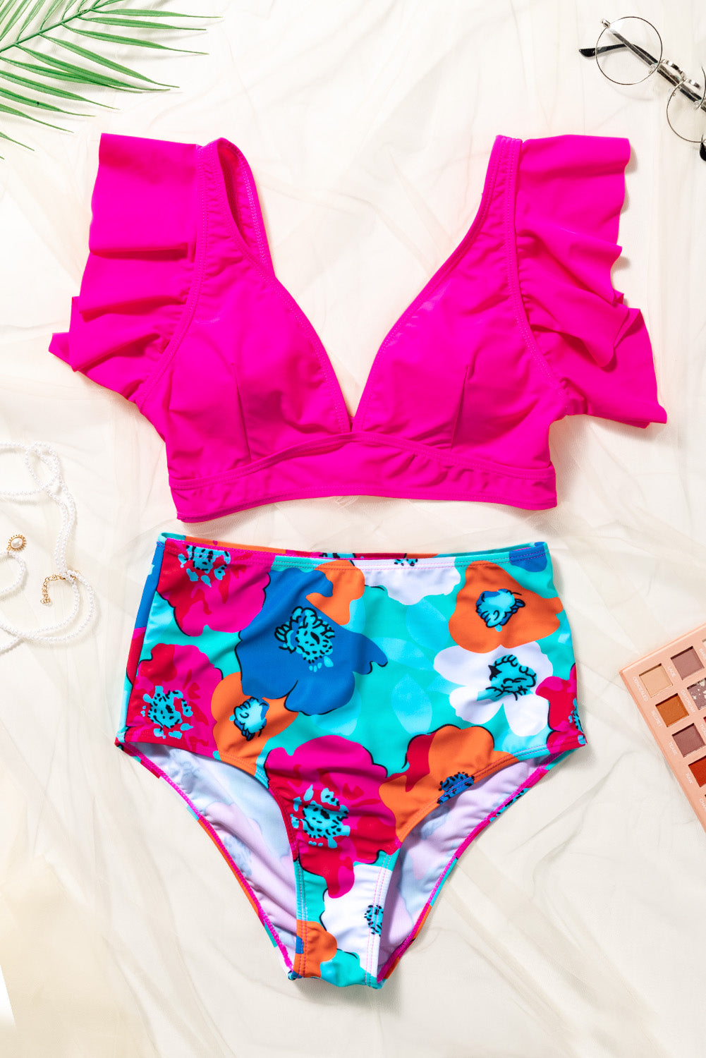 Brighten your beach days with our pink ruffle top and vibrant floral high-waisted swim set—perfect for stylish comfort and fun in the sun.