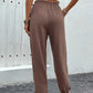 Relaxed-fit brown pants featuring a tie waistband.