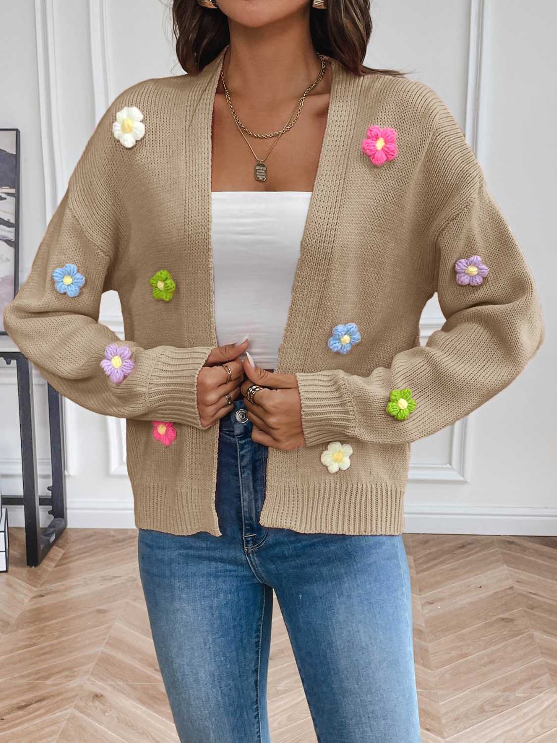 Tan cardigan with colorful knitted flower accents.