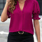 Magenta notched short sleeve blouse featuring ruffled cuffs