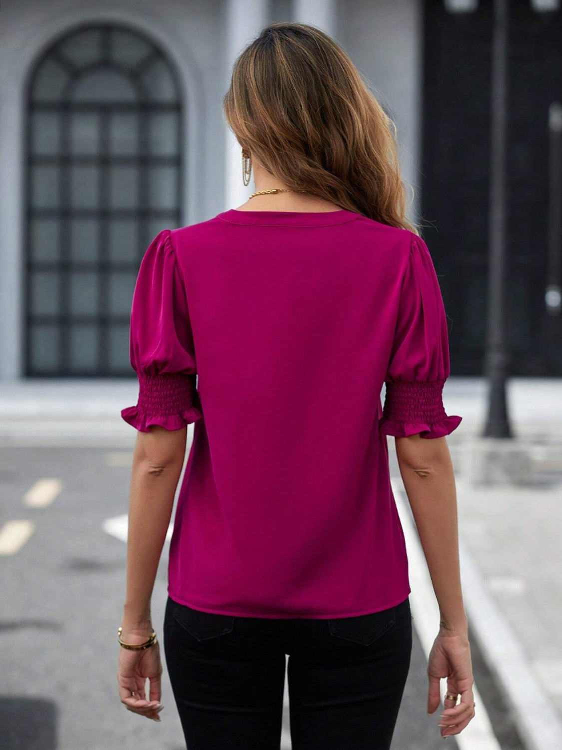 Vibrant magenta blouse with notched neckline and ruffled sleeve design