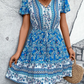 Lightweight blue bohemian dress with adjustable waist tie, ideal for casual events.
