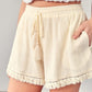Ivory linen fringe shorts with elastic waistband