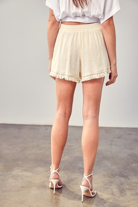 Ivory linen fringe shorts with elastic waistband