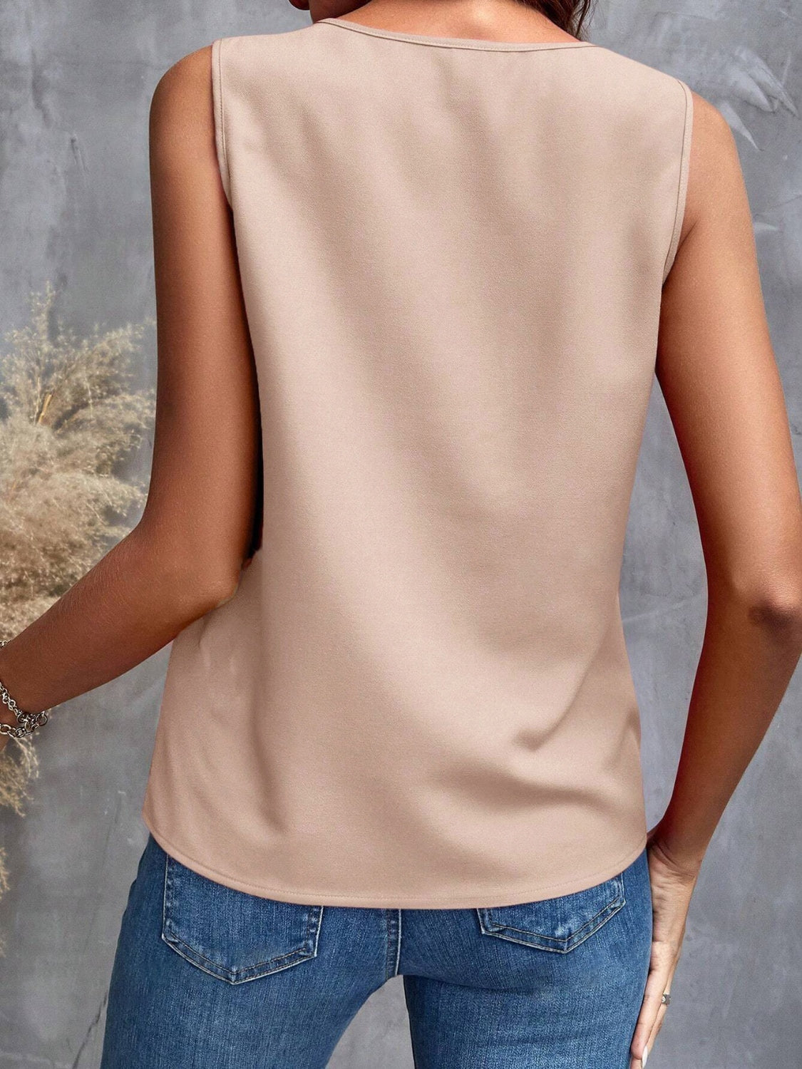 Stylish beige ruffle top paired with jeans, great for casual outings
