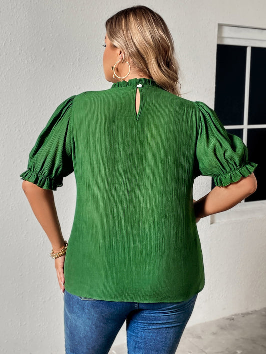 Back view of a trendy green top featuring comfortable puff sleeves and a keyhole detail