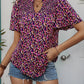 Stylish Southern Charm Smocked Blouse featuring a colorful print, paired with jeans for a chic look