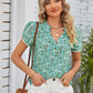 Green floral print blouse with notched neckline and puff sleeves
