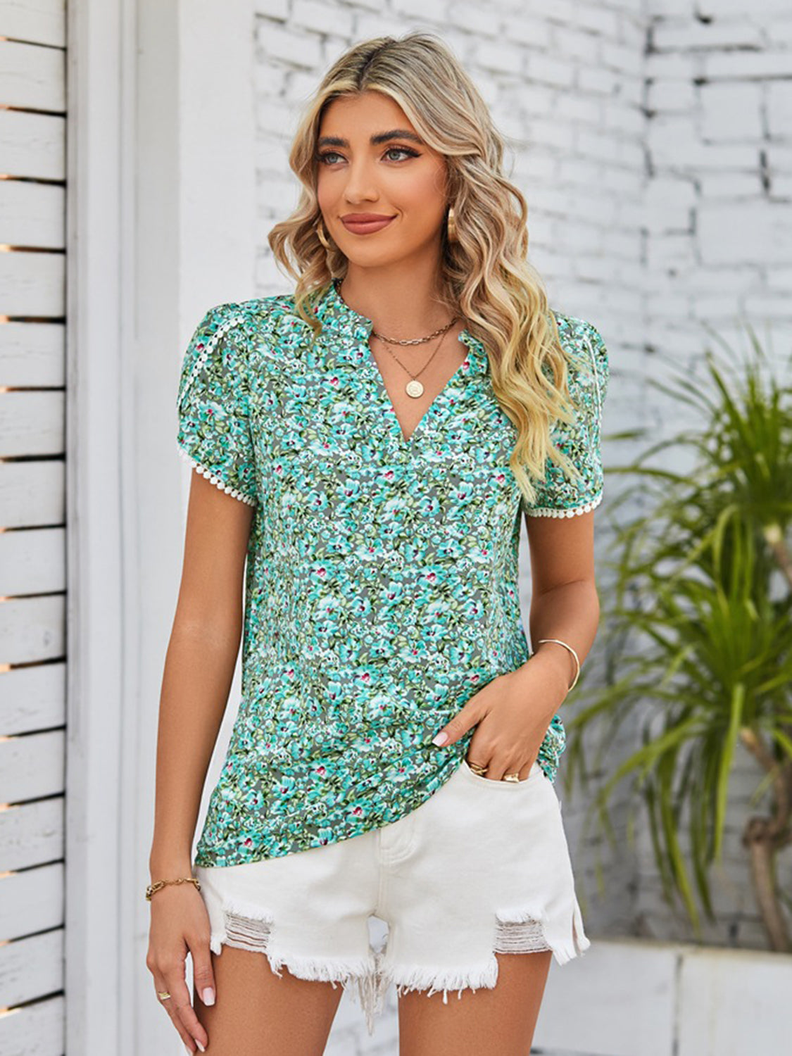 Green floral blouse with a notched neck and puff sleeves for a trendy look