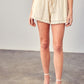 Classic ivory linen shorts with fringe and tassel details