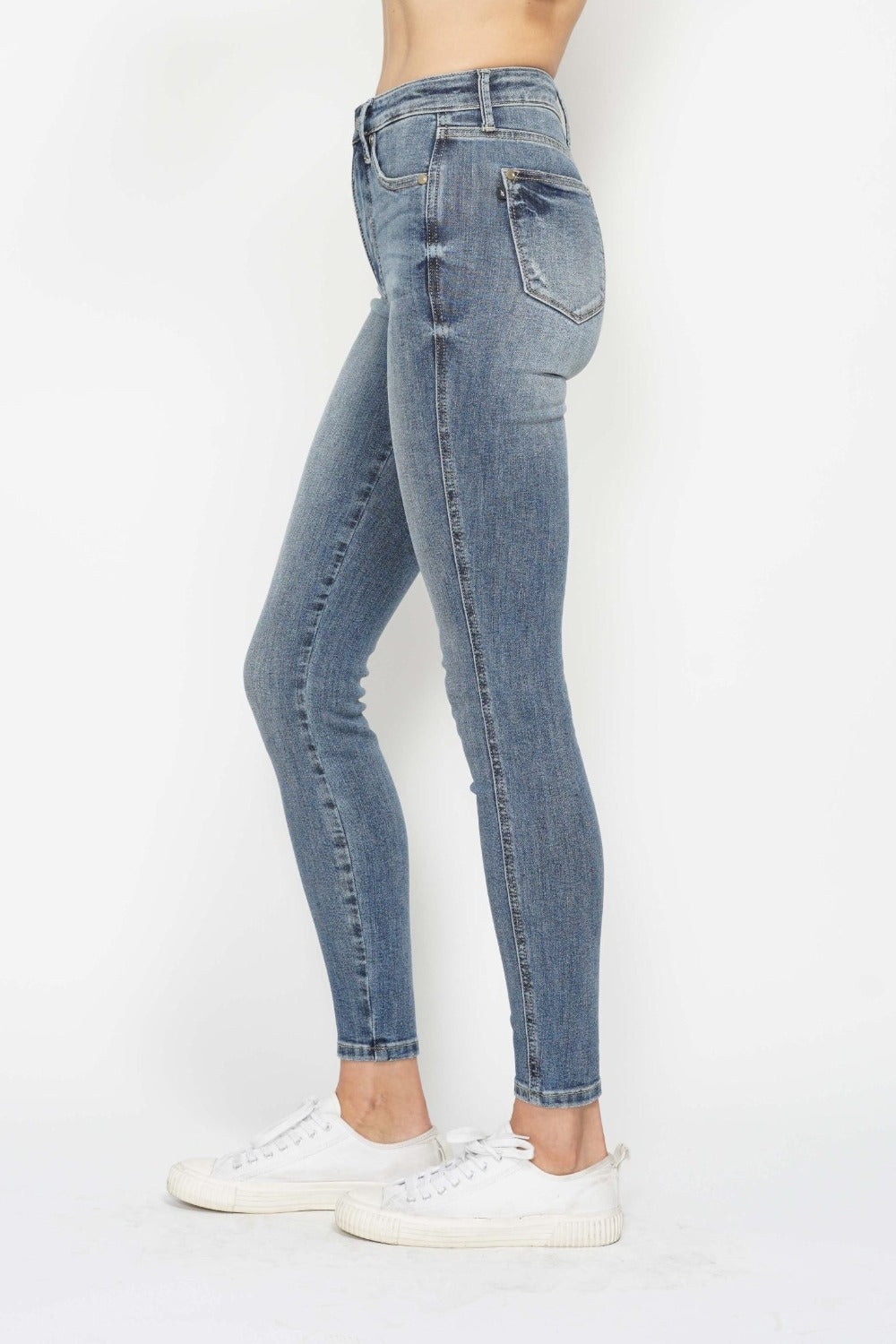 Judy Blue tummy control jeans styled with casual white sneakers.
