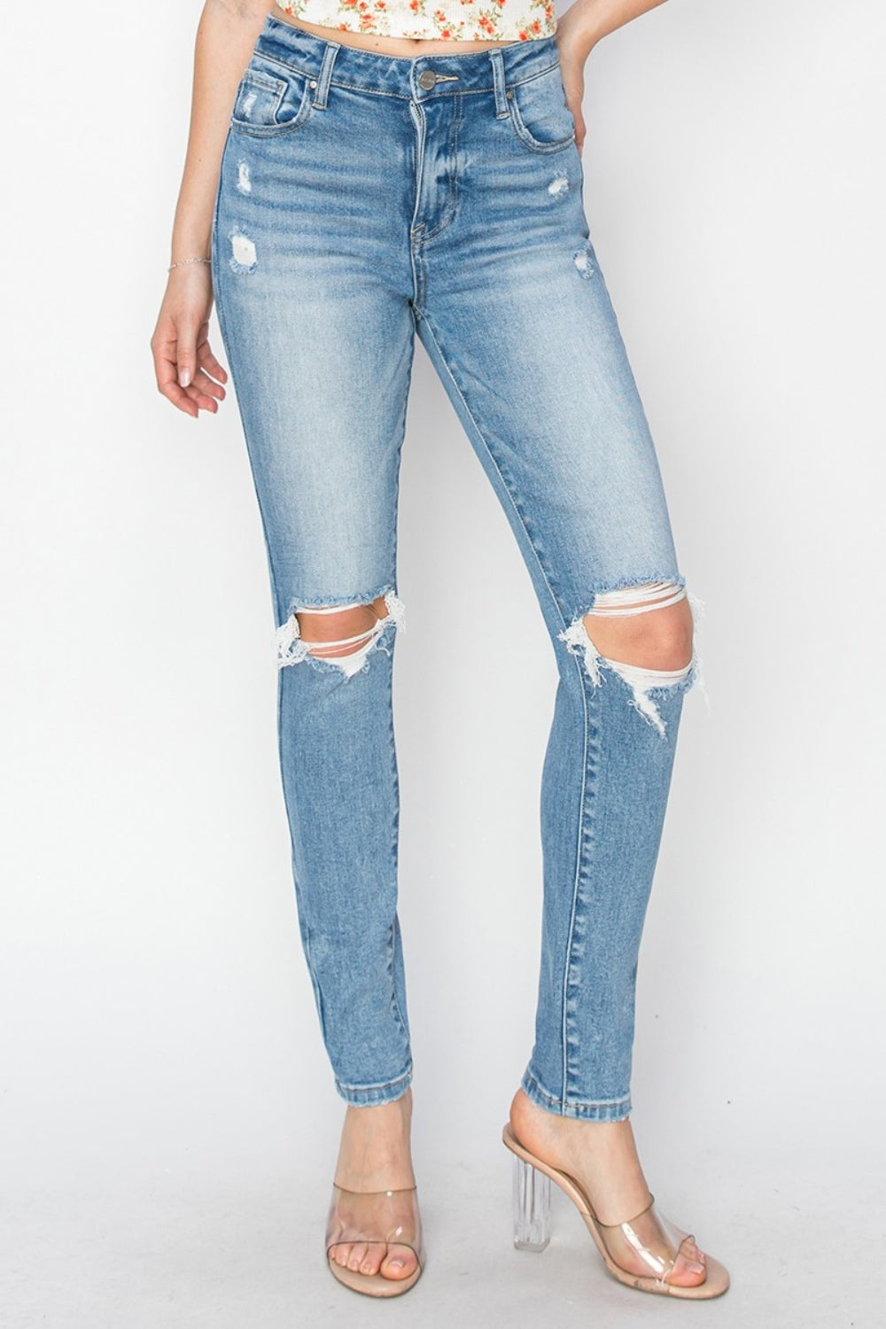 Sleek high-rise skinny jeans in medium-wash with distressed accents
