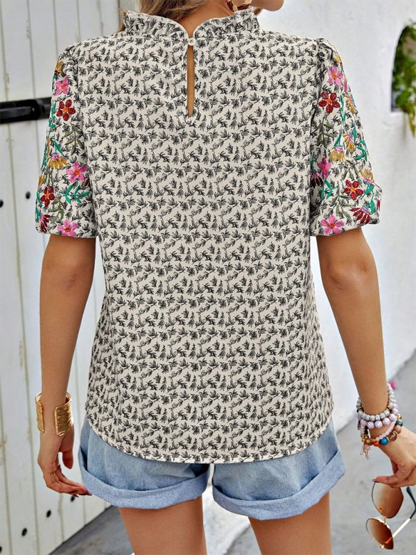 Elegant embroidered shirt with floral motifs