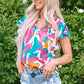 colorful notched neck blouse with vibrant pink, turquoise, orange, and white patterns, perfect for summer